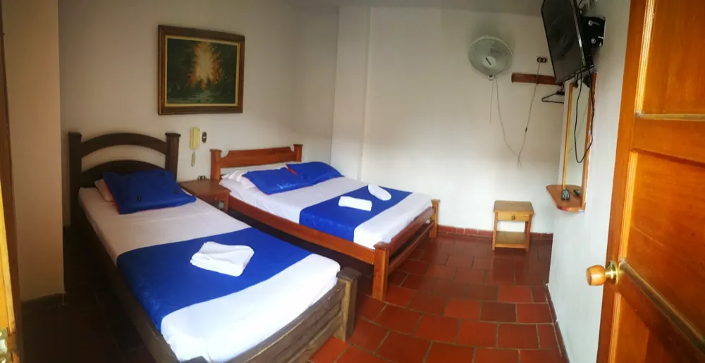 Habitación doble del hotel con dos camas y cuadro sobre la pared